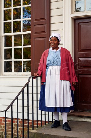 Woman in traditional dress Colonial Williamsburg Virginia USA