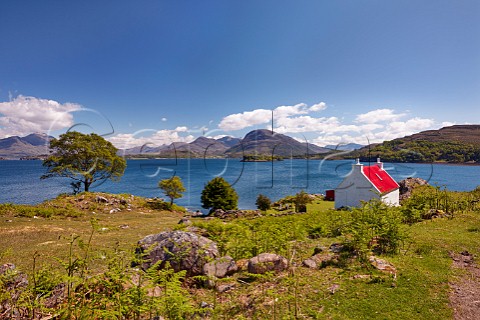 Cottage on coast above Loch Shieldaig Applecross Peninsula Ross and Cromarty Scotland