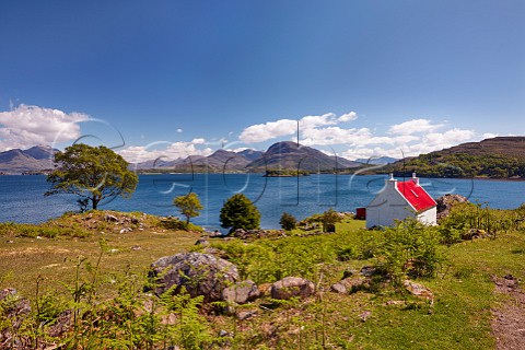 Cottage on coast above Loch Shieldaig Applecross Peninsula Ross and Cromarty Scotland