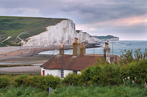 Coastguard cottages at Seaford Head above the Cuckmere River with the Seven Sisters beyond Sussex England