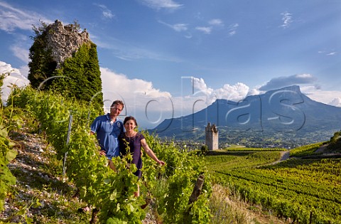 JeanFranois and Catherine Quenard in Bergeron vines by the ruined tower in their vineyards at Les Tours de Chignin Mont Granier in distance Domaine JeanFranois Quenard Chignin Savoie France