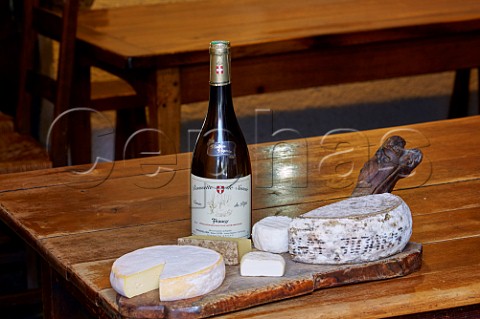 Local cheeses and bottle of Cuve du Pp Roussette de Savoie in Auberge Cave de la Ferme of Domaine Lupin Frangy HauteSavoie France