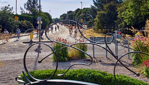 Riders in the 2016 Ride LondonSurrey 100 passing the cyclist sculpture at West Molesey commissioned to commemorate the 2012 Olympic Games Surrey England    31 July 2016