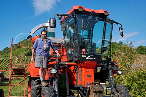 Guy Quenard with harvesting machine  his vineyards are on the hill beyond  Domaine Claude Quenard et Fils Chignin Savoie France