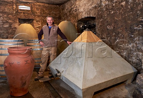 Dominique Lucas with pyramid amphora concrete eggs and barrels in cellar of Les Vignes de Paradis Marcorens Ballaison HauteSavoie France