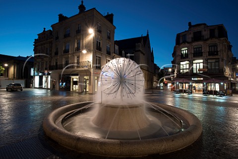 Fountain and cobbled street at dawn Reims Marne France Champagne