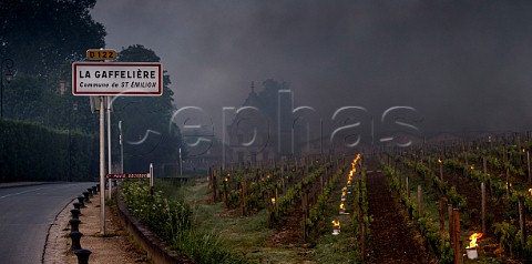 Oil burning smudge pots in vineyard of Chteau La Gaffelire during subzero temperatures of April 2017 Stmilion Gironde France Saintmilion  Bordeaux