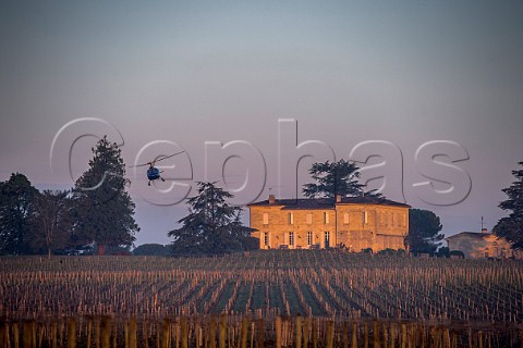 Helicopter being used to circulate warmer air and prevent frost damage to vineyard in subzero spring temperatures of April 2017  Chteau Figeac Stmilion Gironde France  Saintmilion  Bordeaux