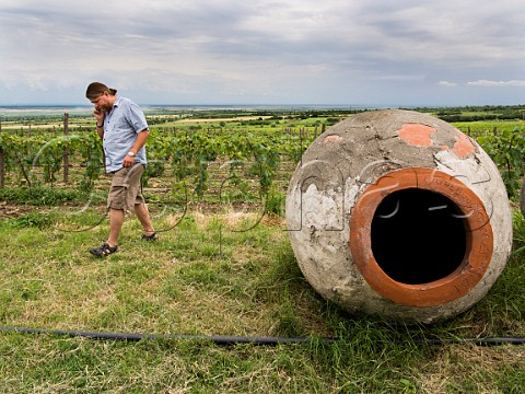John H Wurdeman V with a disused qvevri in vineyard of Pheasants Tears  Sighnaghi Kakheti eastern Georgia