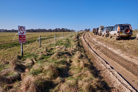 Offroad vehicles on Public Byway with danger sign warning of live firing Salisbury Plain Wiltshire England