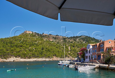 Village of Assos with houses and taverna overlooking its bay and the castle atop its peninsula Cephalonia Ionian Islands Greece