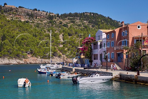 Village of Assos with houses and taverna overlooking its bay and the castle atop its peninsula Cephalonia Ionian Islands Greece