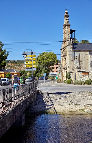 Pilgrims walking the Camino de Santiago by the Santuario de Quinta Angustia at Cacabelos Castilla y Len Spain