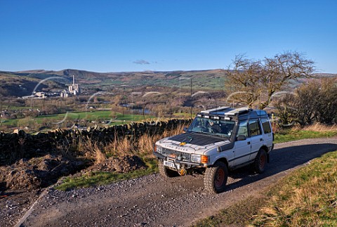 Land Rover on a Green Lane with Breedon Hope Cement Works in distance Near Bradwell Peak District National Park Derbyshire England