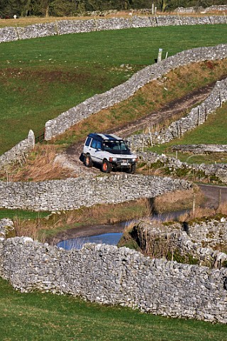 Land Rover on Tideswell Lane a Green Lane near Eyam Peak District National Park Derbyshire England