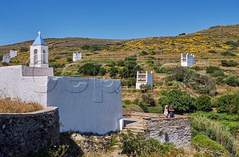 Chapel at Tarampados with some of the numerous dovecots near the village Tinos Greece