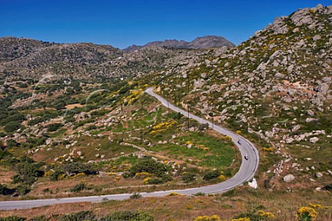 Motorcyclists on road near Volakas village on the Volax Plateau Tinos Greece