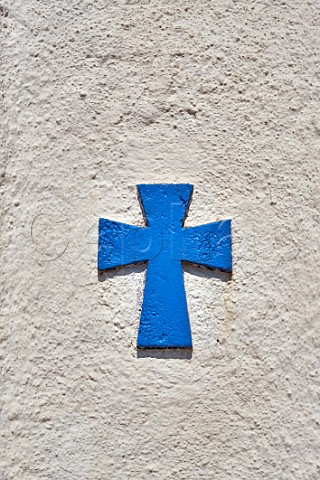 Cross on wall of chapel at Tripotamos Tinos Greece