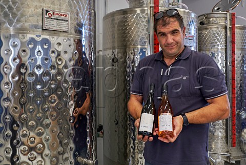 John Vaptistis Moraitis with two of his wines Vaptistis white and Altana ros Vaptistis Winery Mesi Tinos Greece