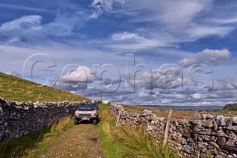 Car on unsurfaced road south of Hawes Yorkshire Dales National Park England