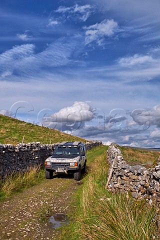 Car on unsurfaced road south of Hawes Yorkshire Dales National Park England