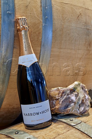 Bottle of Harrow  Hope Brut Reserve NV with a flint rock from the vineyard Marlow Buckinghamshire England