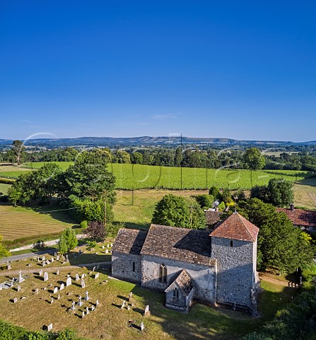 The 11thcentury church of St Mary the Virgin with Stopham Estate Vineyard beyond and the South Downs in the distance Stopham Sussex England