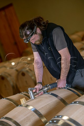 Cyril Meyrou filling new oak barriques in the cellar of Chteau Richelieu Fronsac Gironde France   Fronsac  Bordeaux
