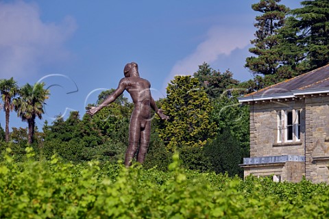 Leonardslee House and Faith sculpture by Anton Smit viewed over Pinotage vineyard Lower Beeding Horsham Sussex England