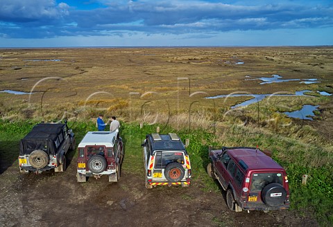 Land Rovers overlooking the salt marshes at Stiffkey Norfolk England