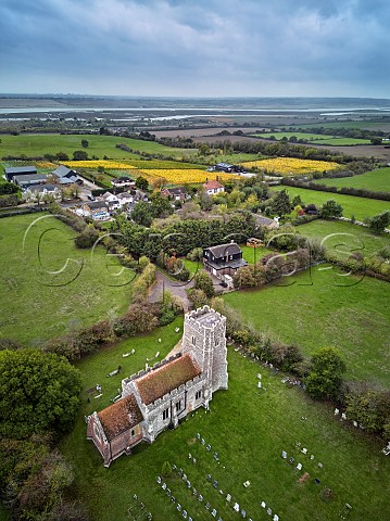 St Andrews Church with autumnal Crouch Ridge Vineyard beyond and River Crouch in distance Althorne Essex England
